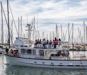 Youth on boat participating in an SBMM educational opportunity.