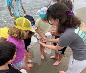 Youth on the beach engaging in an SBMM educational opportunity.