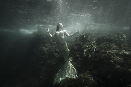 Photographer Ralph Clevenger photograph of mermaid under the water.