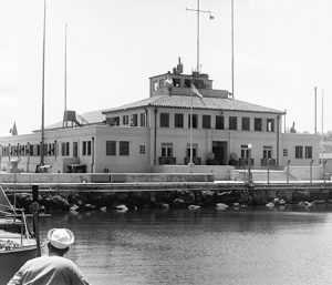 View of maritime museum with sailor in foreground.