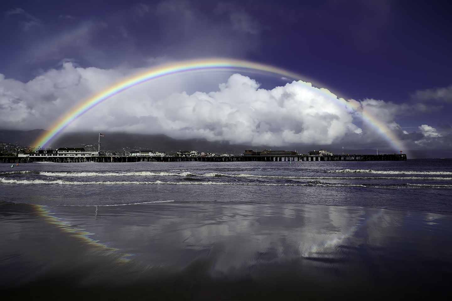 Photograph of a rainbow over Sterns Wharf in Santa Barbara taken by Dan Merkel.